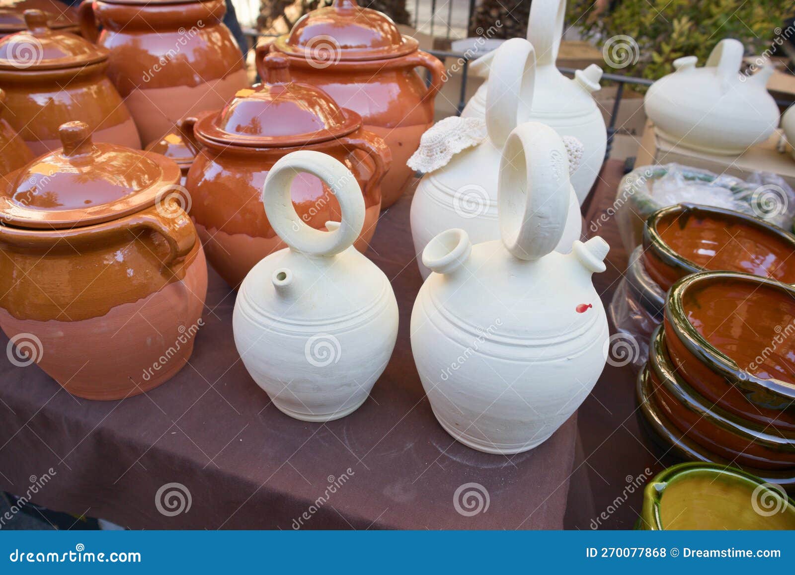 closeup of some botijos and ceramic jugs in a traditional market