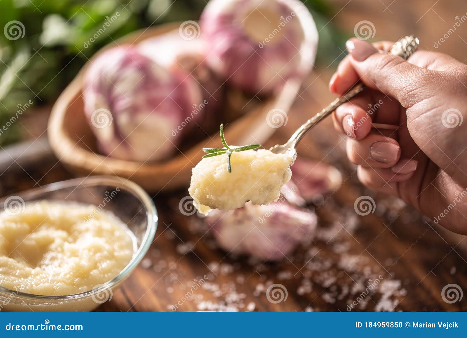 Detail of a Teaspoon of Garlic Paste with Fresh Garlic in the