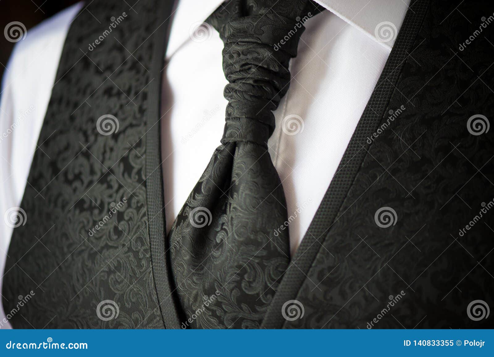 detail of tie and boyfriend vest