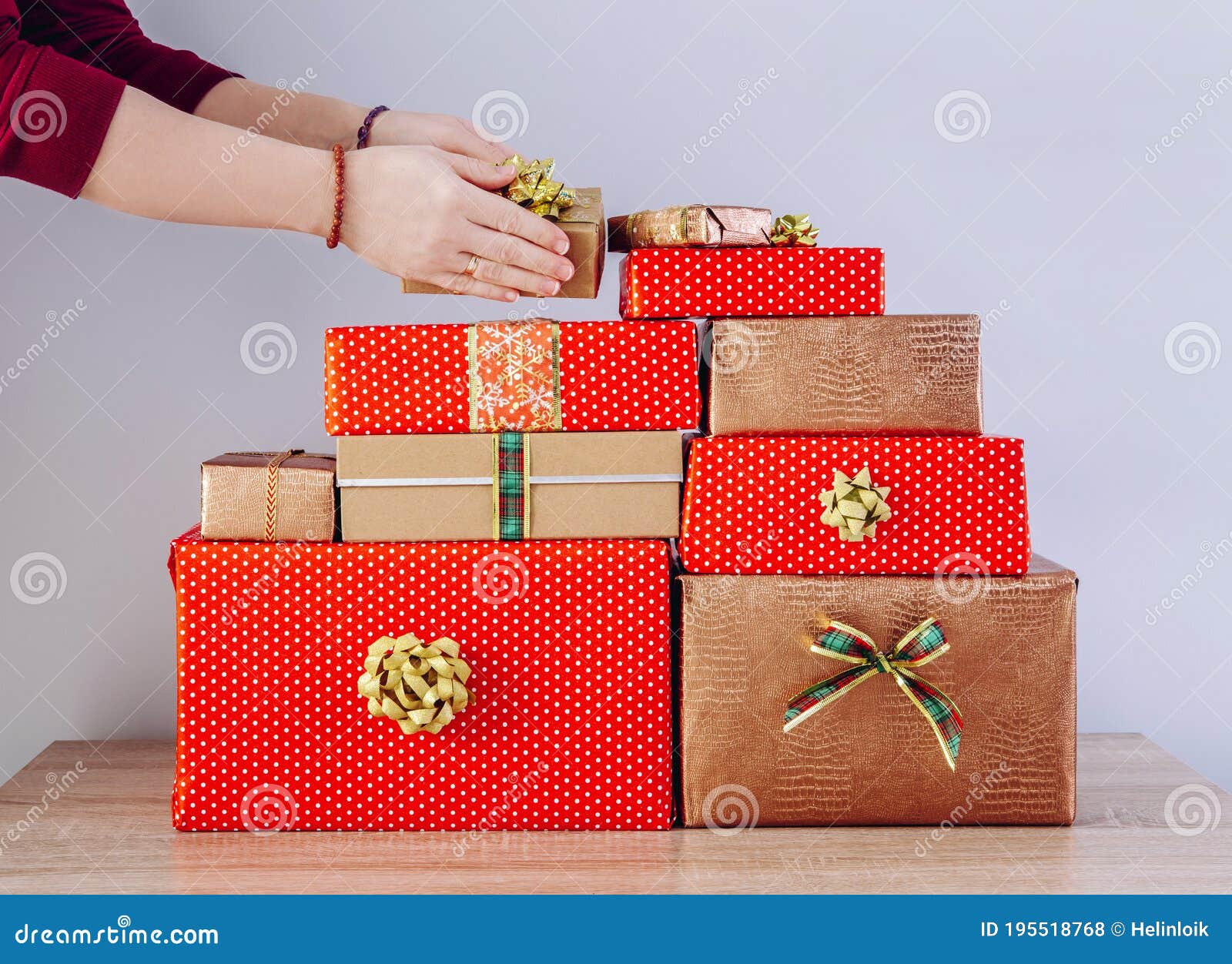 Detail View of Woman Person Hands Stacking Christmas Presents in a Pile ...