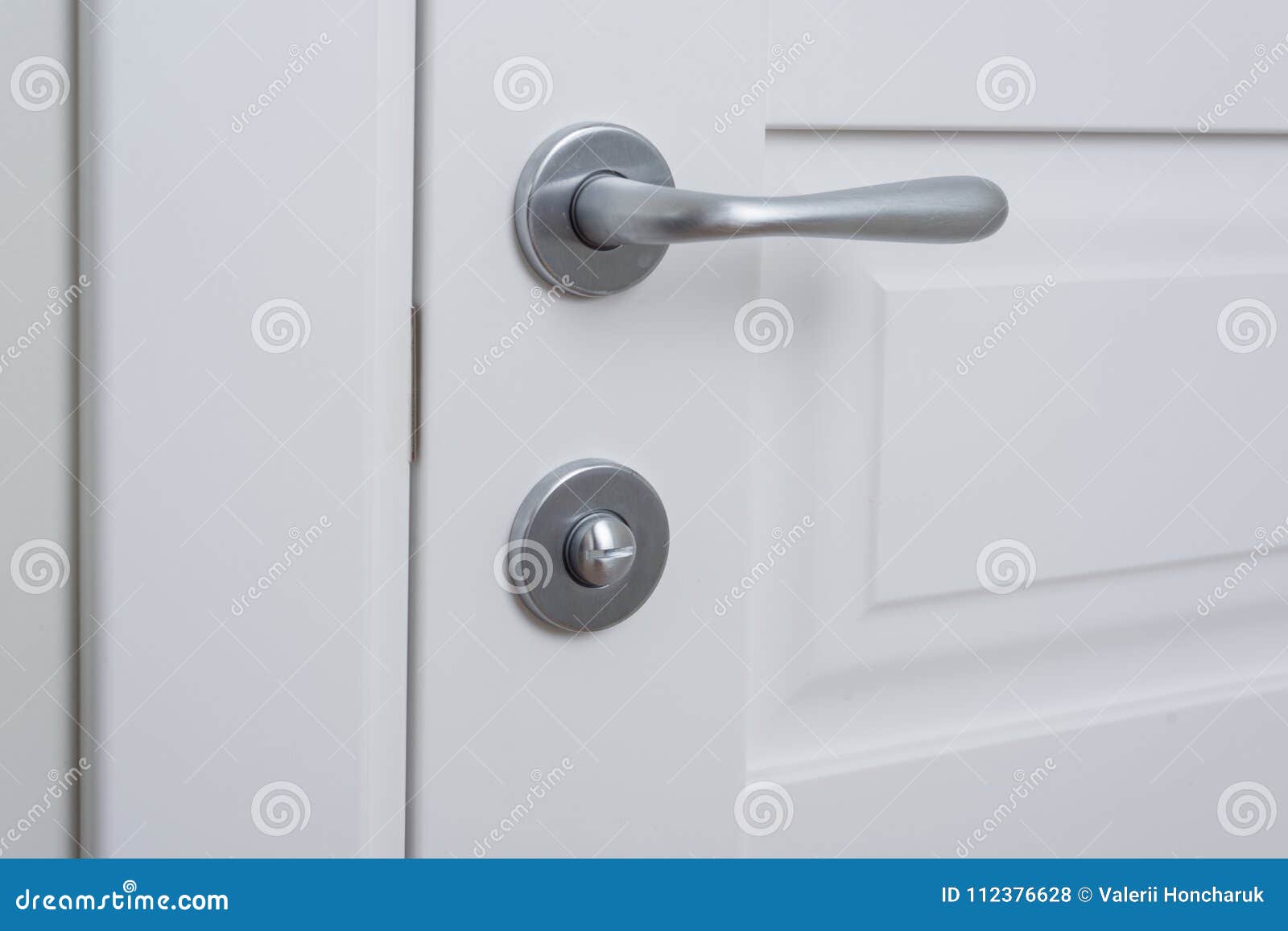 Detail Of A White Interior Door With A Chrome Door Handle And