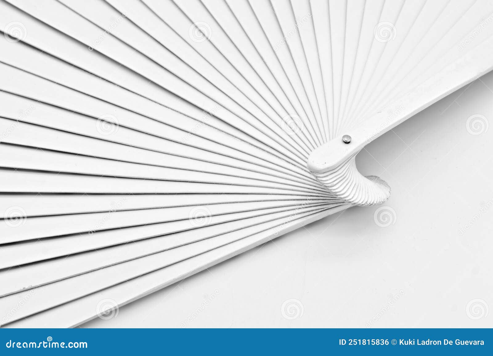 detail of a white painted wooden fan