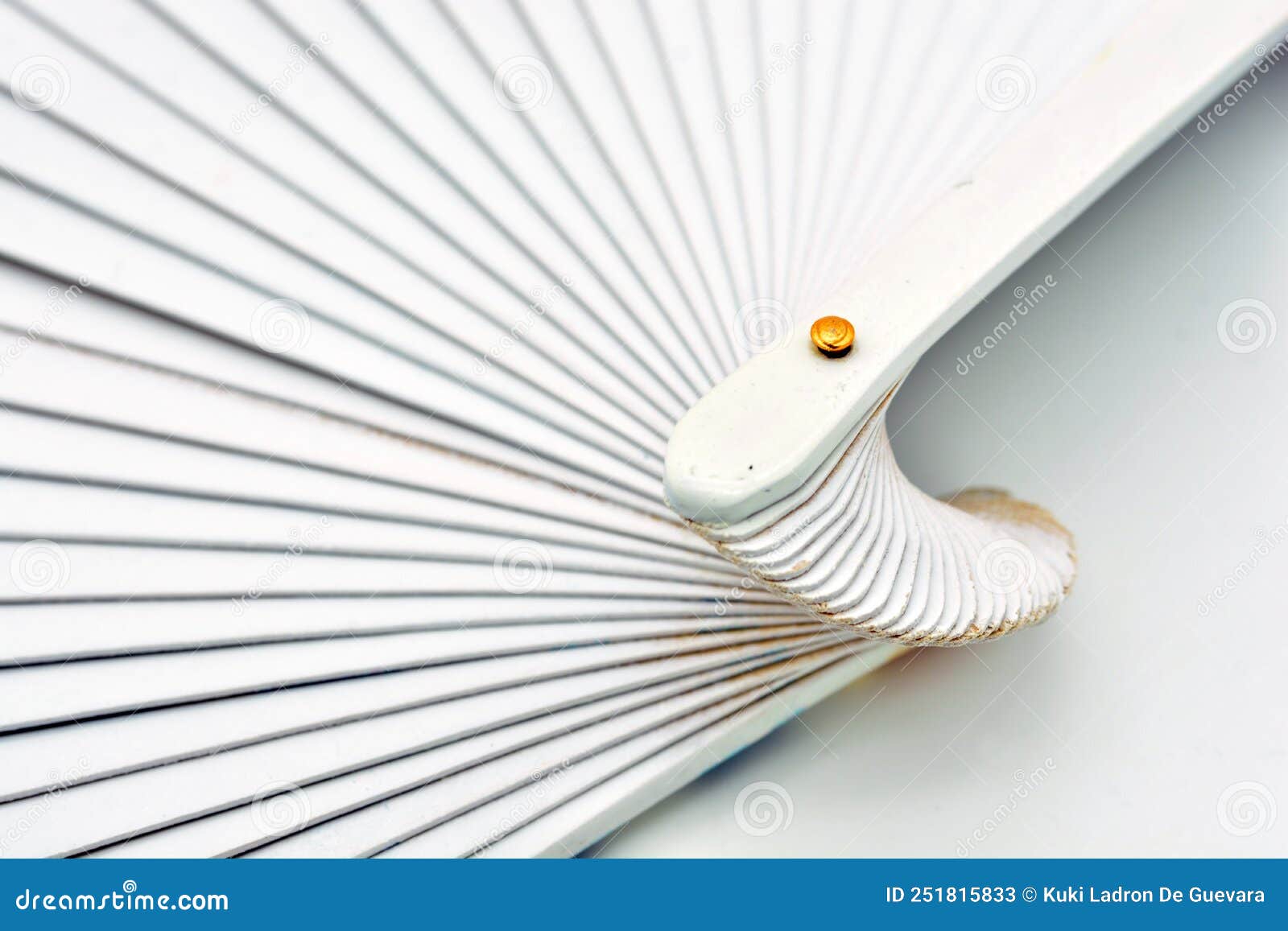 detail of a white painted wooden fan