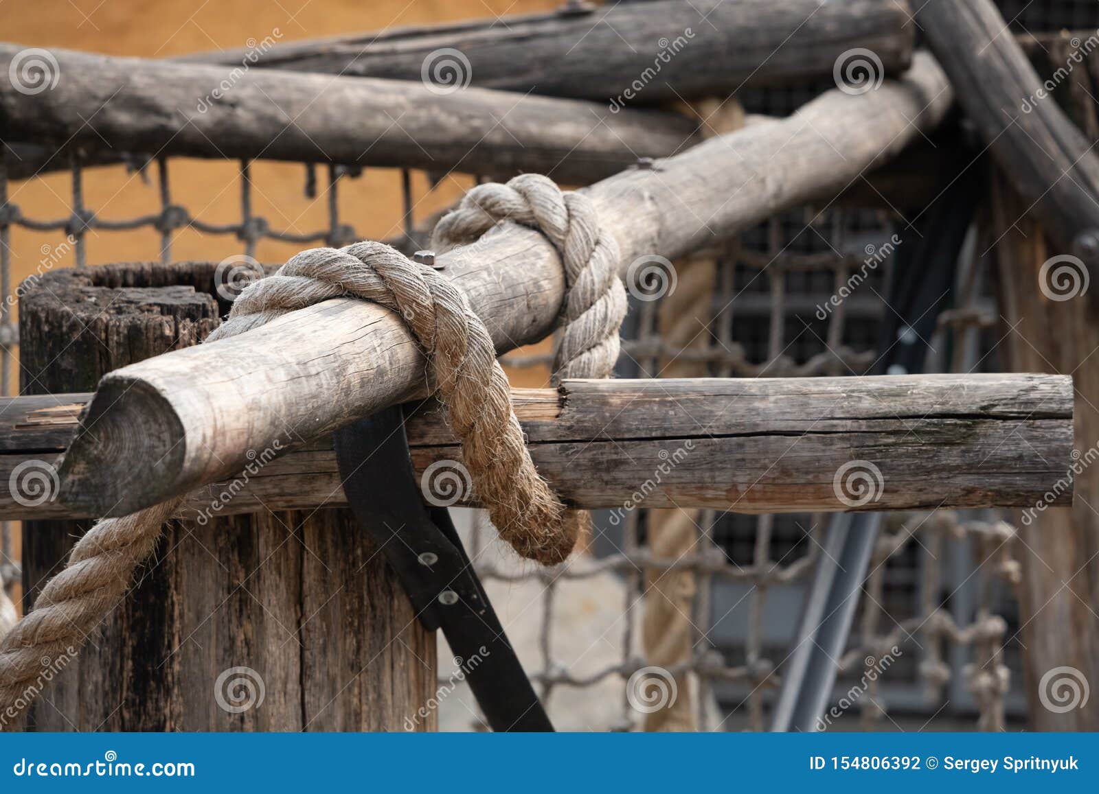 detail of a wooden construction of the beams in the background with a forest.city and forest gym, details of exercise aids made of
