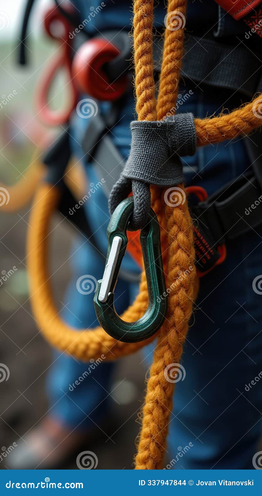 close-up of workers with safety rope and carabiner in harness