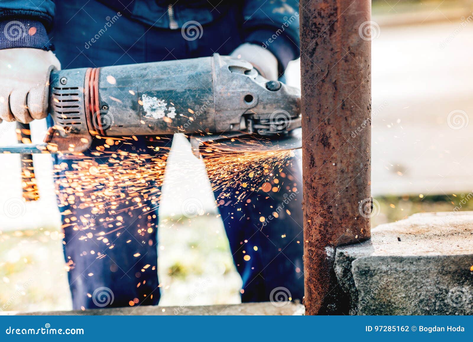 Details of Construction Worker Cutting Metal Bars Using Angle Grinder