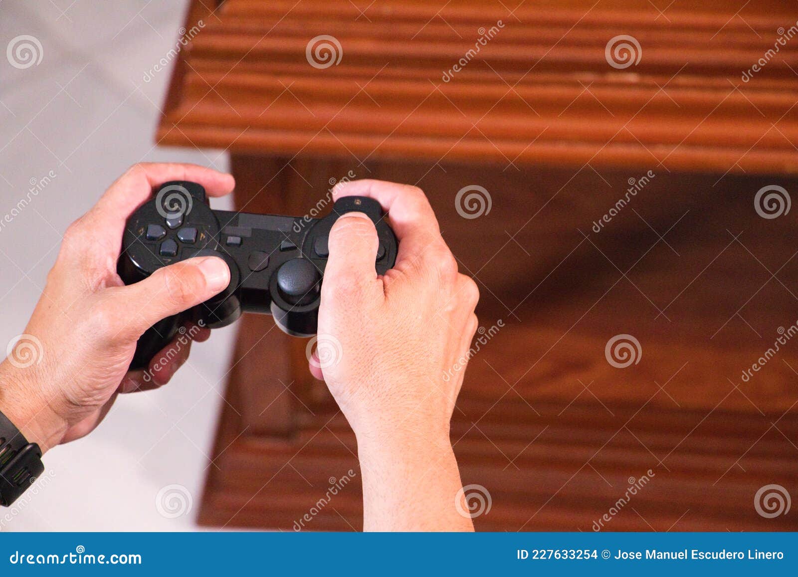 Details of Hands of a Man Holding a Video Console Controller, the Man
