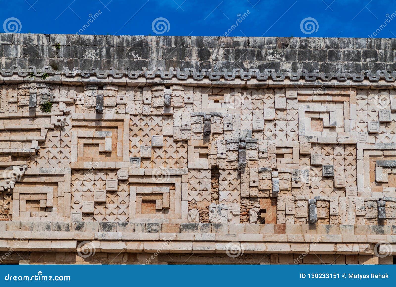 detil of the stonework at the palacio del gobernador governor`s palace building in the ruins of the ancient mayan city