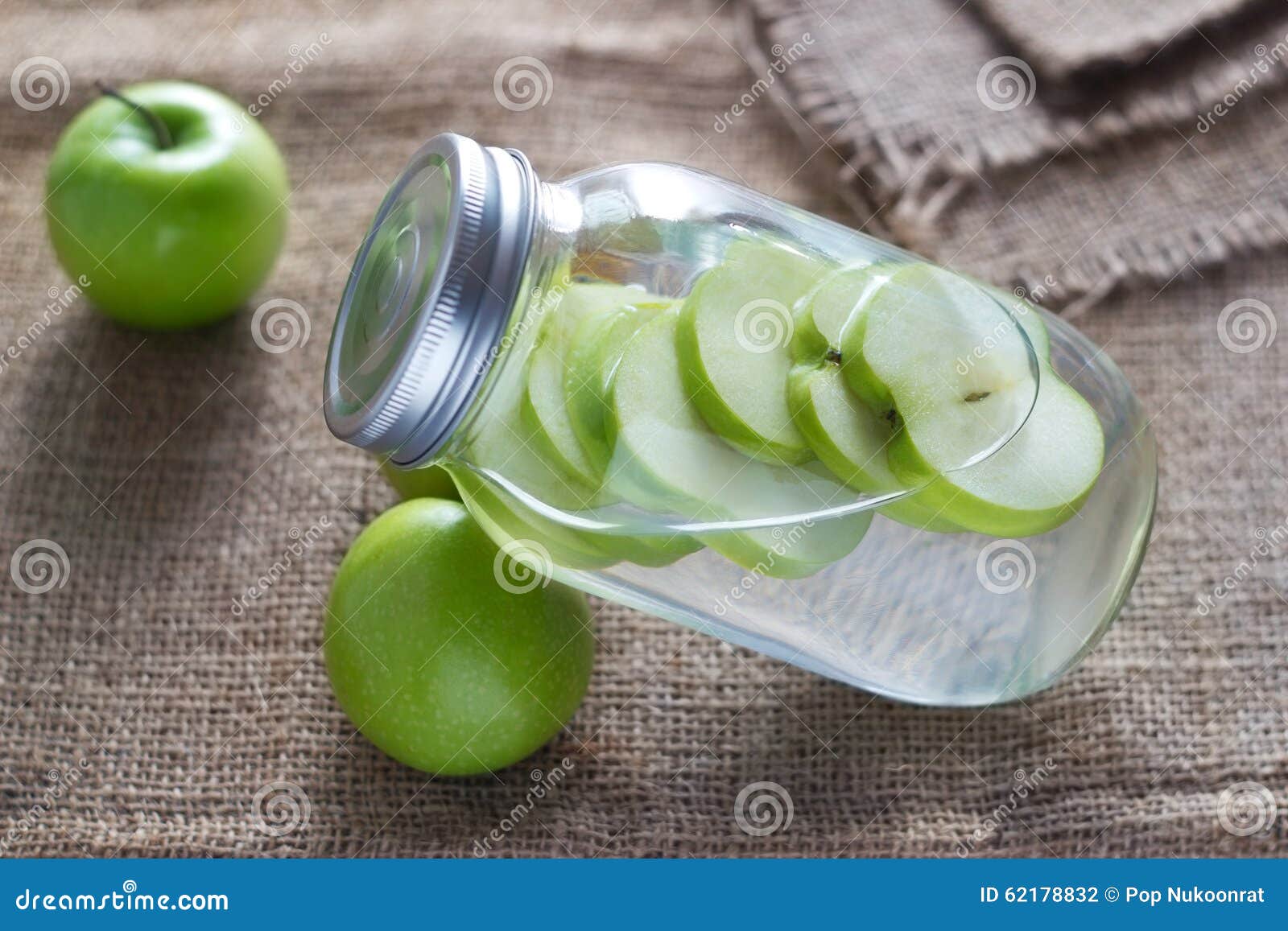 detox diet fresh green apples soak in water of the jar on sack