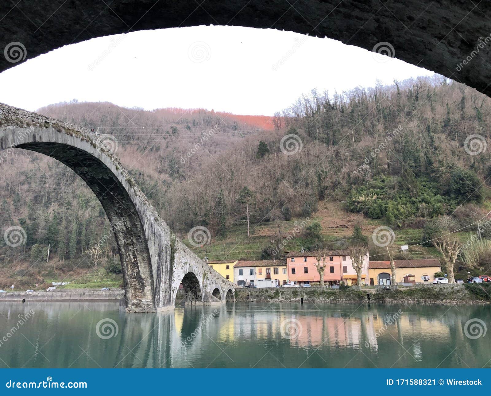 Devil Bridge Surrounded by Hills Covered in Greenery and Houses