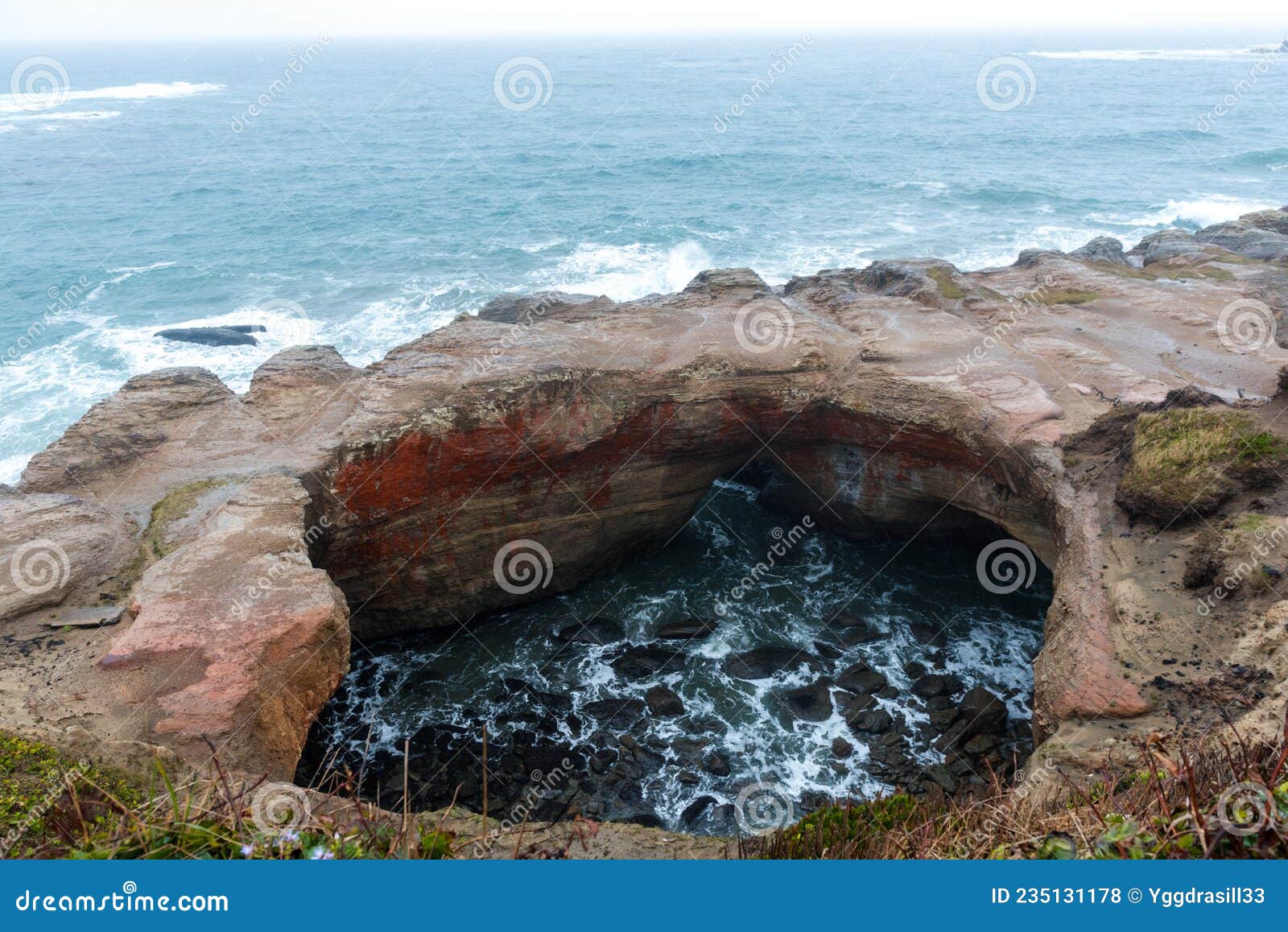 Devils Punchbowl Arch on the Shore of Oregon Coast Stock Photo Image