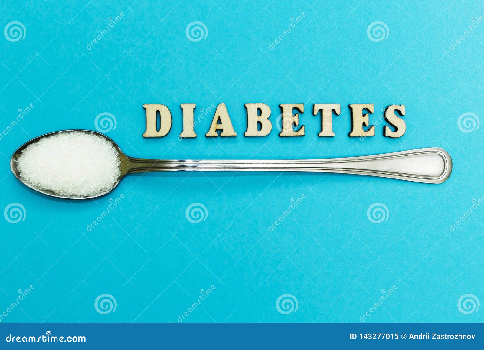 Diabetes Inscription, Spoon with Sugar on a Blue Background Stock Image