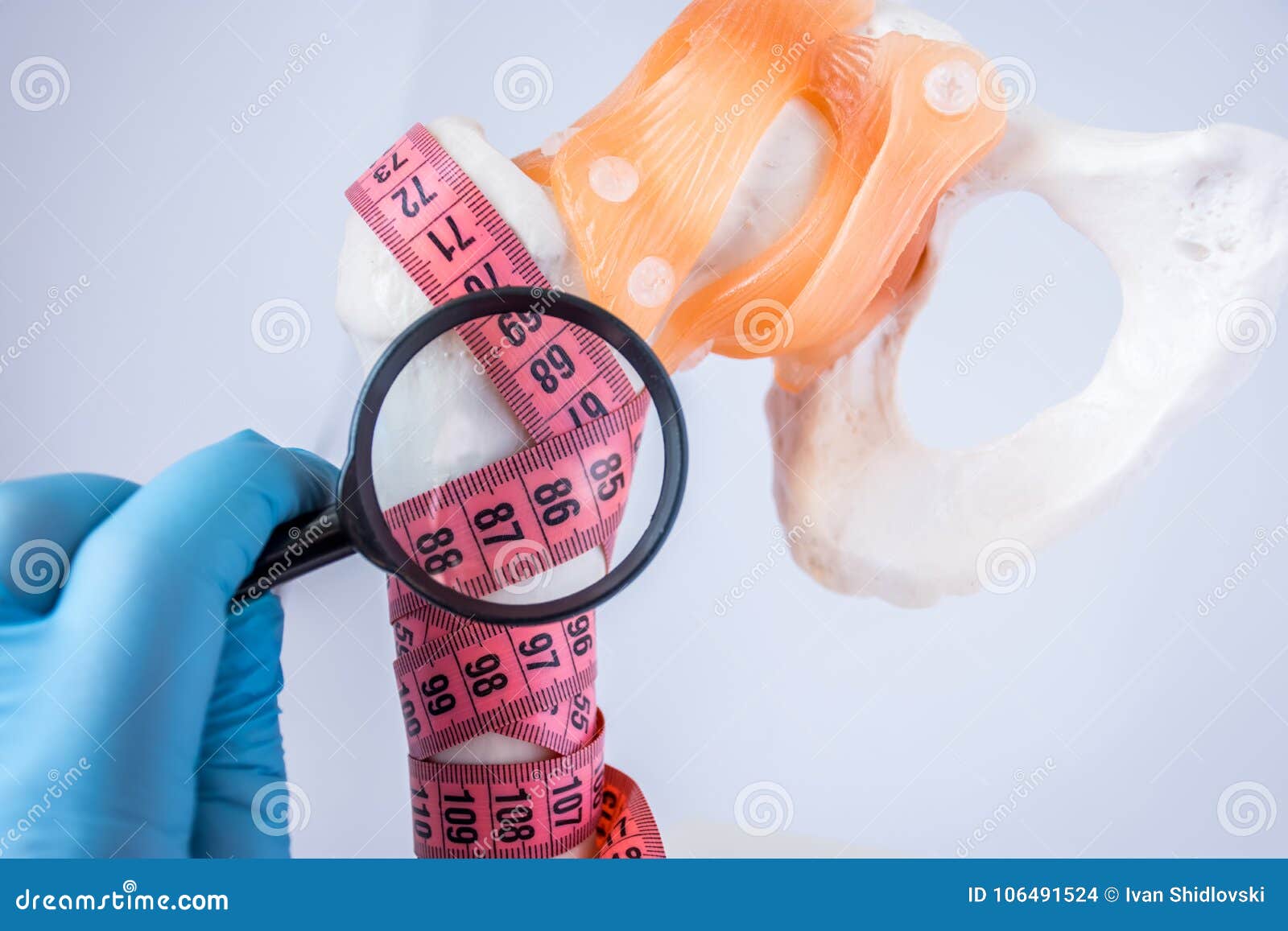 diagnosis of bone density and presence of osteoporosis photo idea. doctor examines through magnifying indicators measuring tape wr