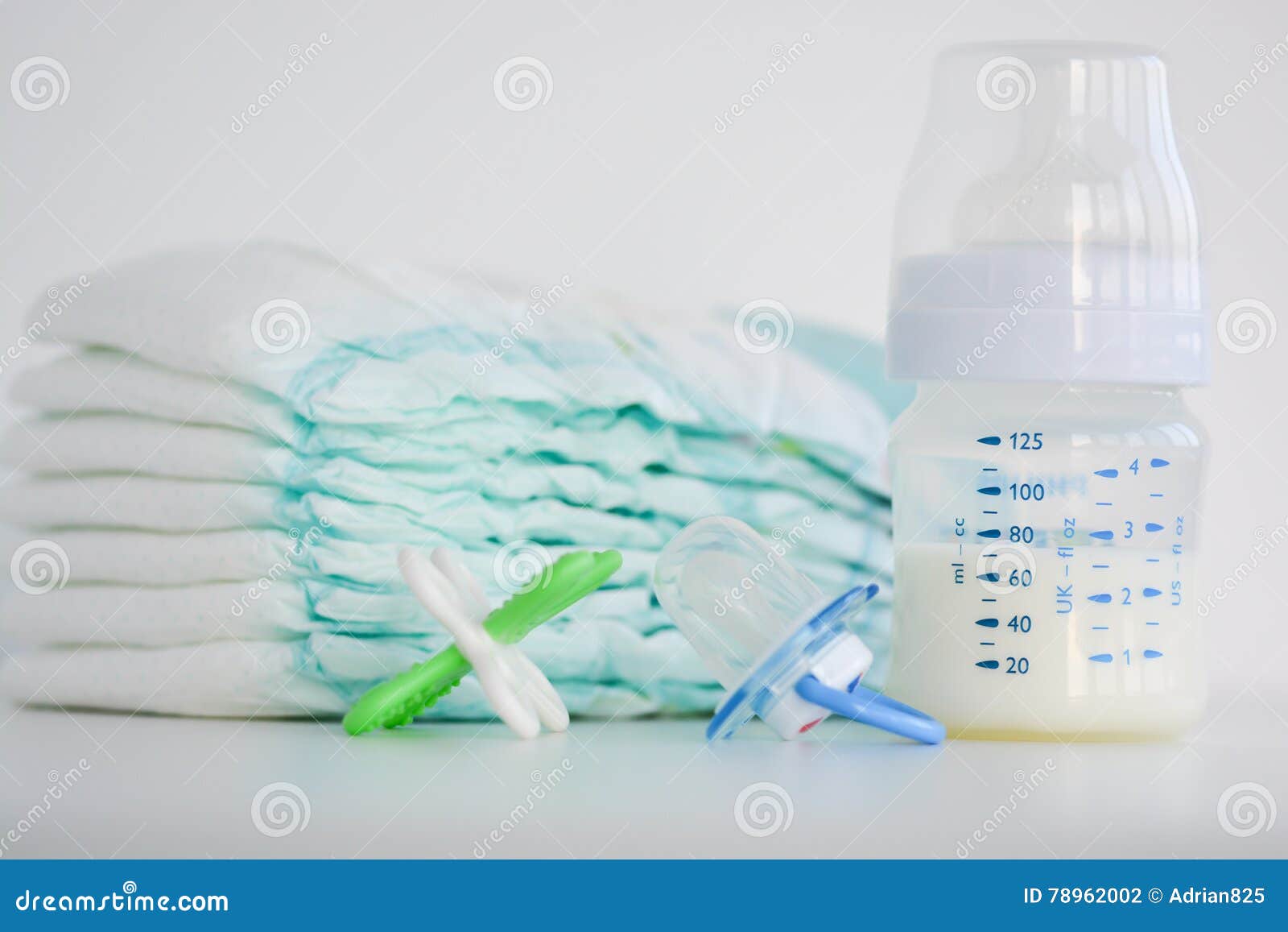 Diapers, Milk Bottle and a Pacifier Stock Photo Image of parenting