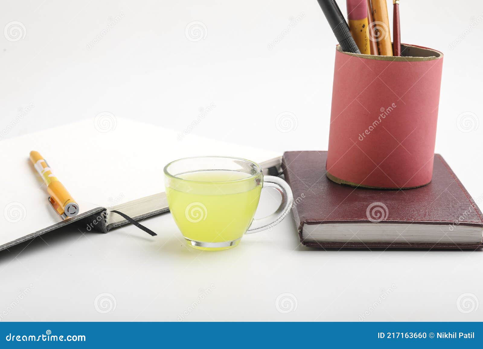 Diary and Pen with Cup of Green Tea. Work from Home Concept Stock Photo