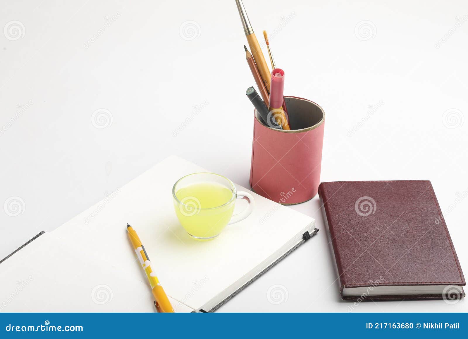 Diary and Pen with Cup of Green Tea. Work from Home Concept Stock Photo
