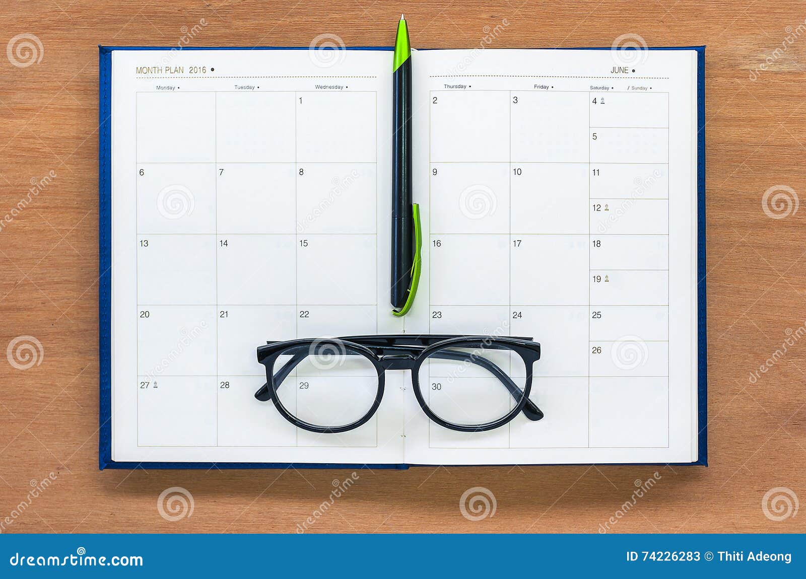 Diary Planner Book Open Calendar Page with Glasses and Pen on Th Stock