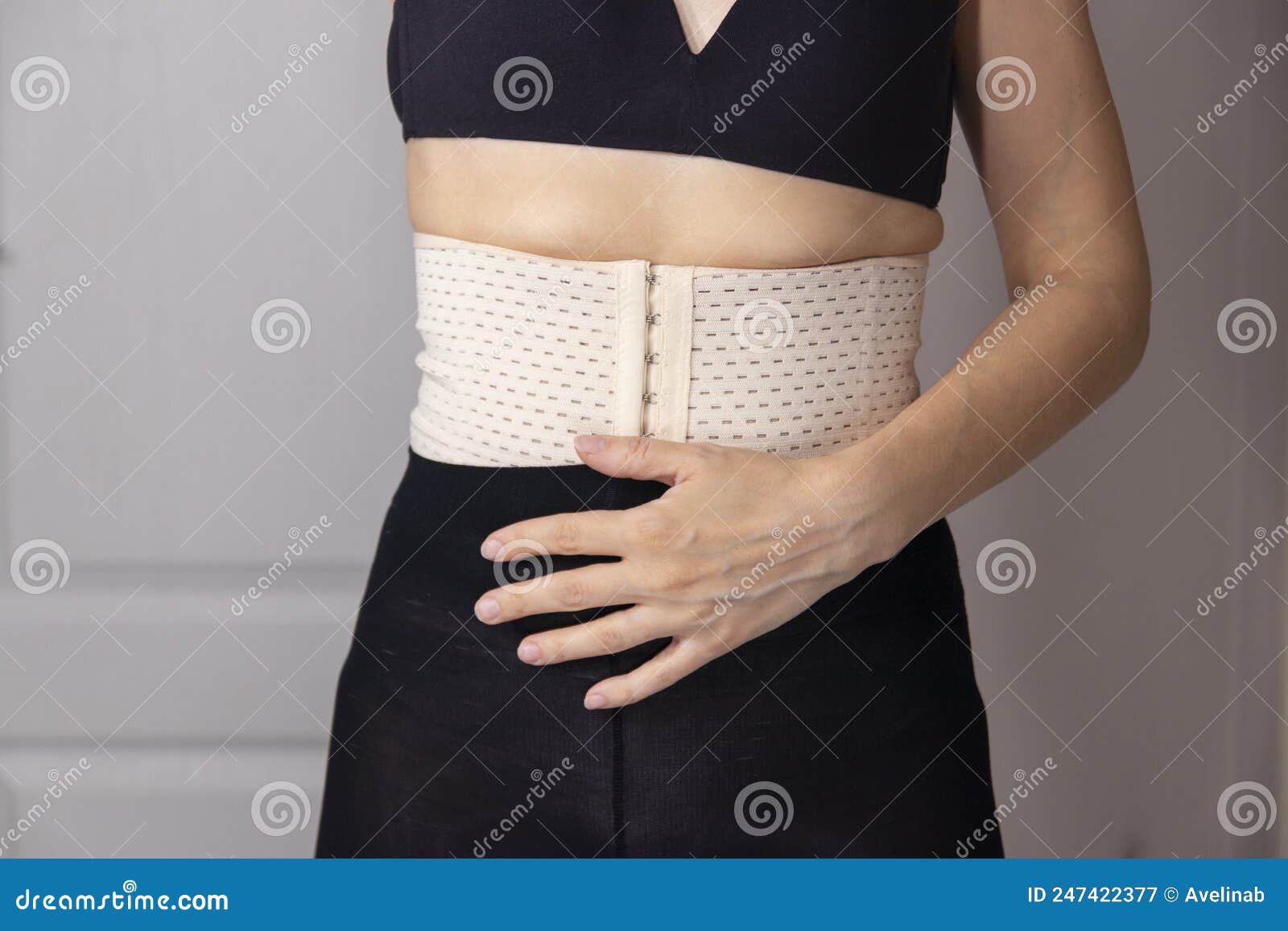 Diastasis Recti after Child Birth. Woman Wearing a Corset To