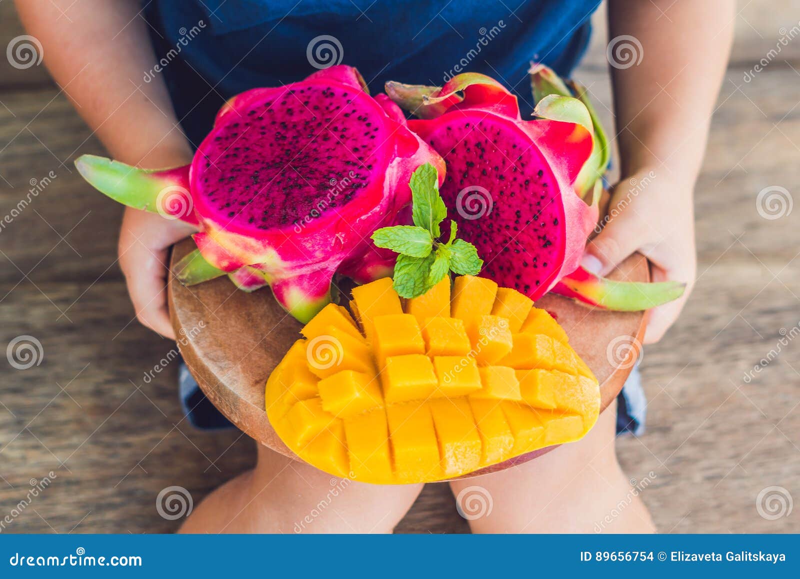 Diced Dragon Fruit and Mango in the Hands of the Boy Stock Photo