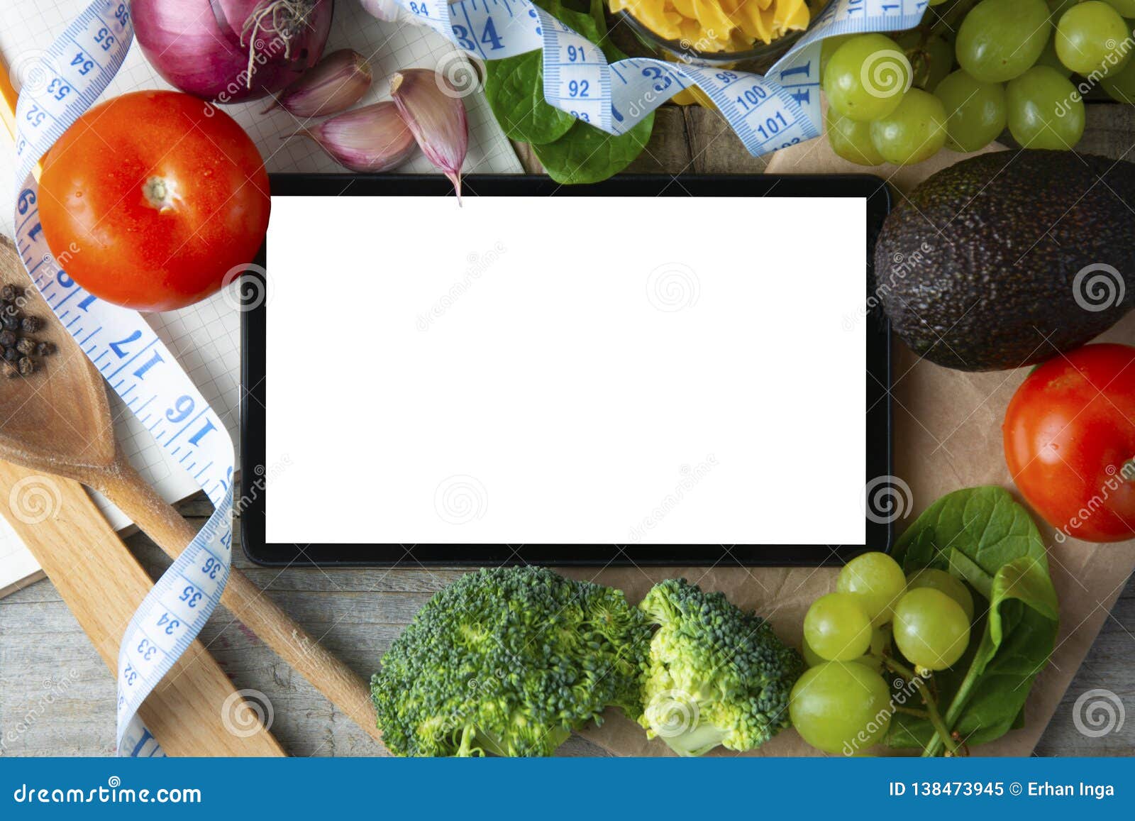 diet plannig. set of raw food with tablet on wooden background with gadget screen with copy space. healthy food concept