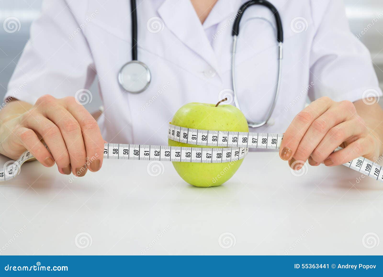 dietician measuring green apple