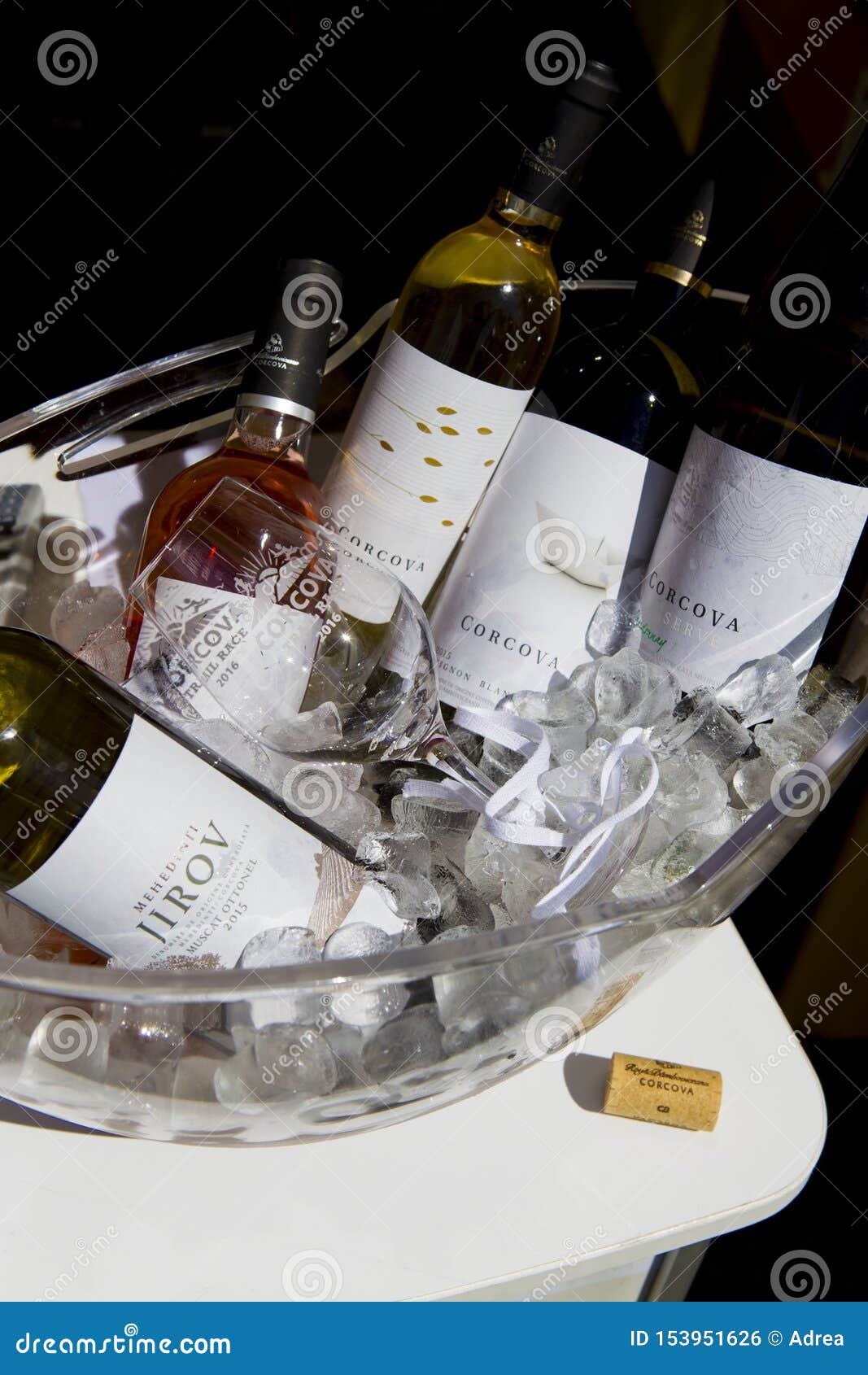 different bottles of wine in a bole with ice