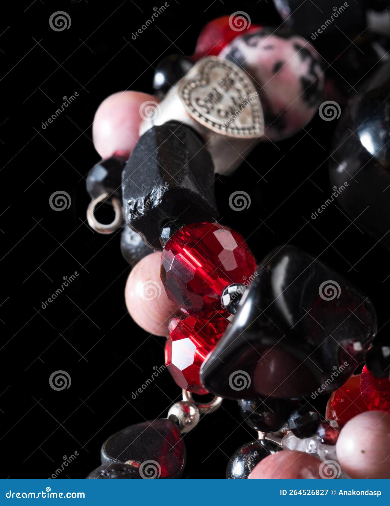 different   bracelets with black and red  semipreciouse stones with natural lava, shungite,  hematite,  rhodonite.  macro shot