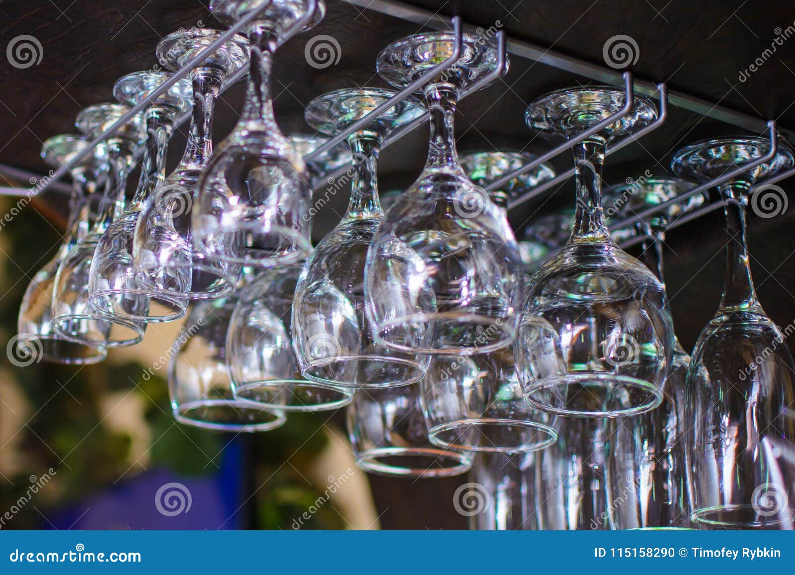 Different Cocktail Glasses Hanging Over a Bar Rack Stock Photo Image
