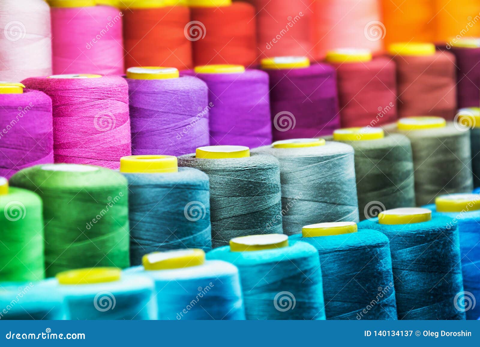 different color spools of thread for the textile industry