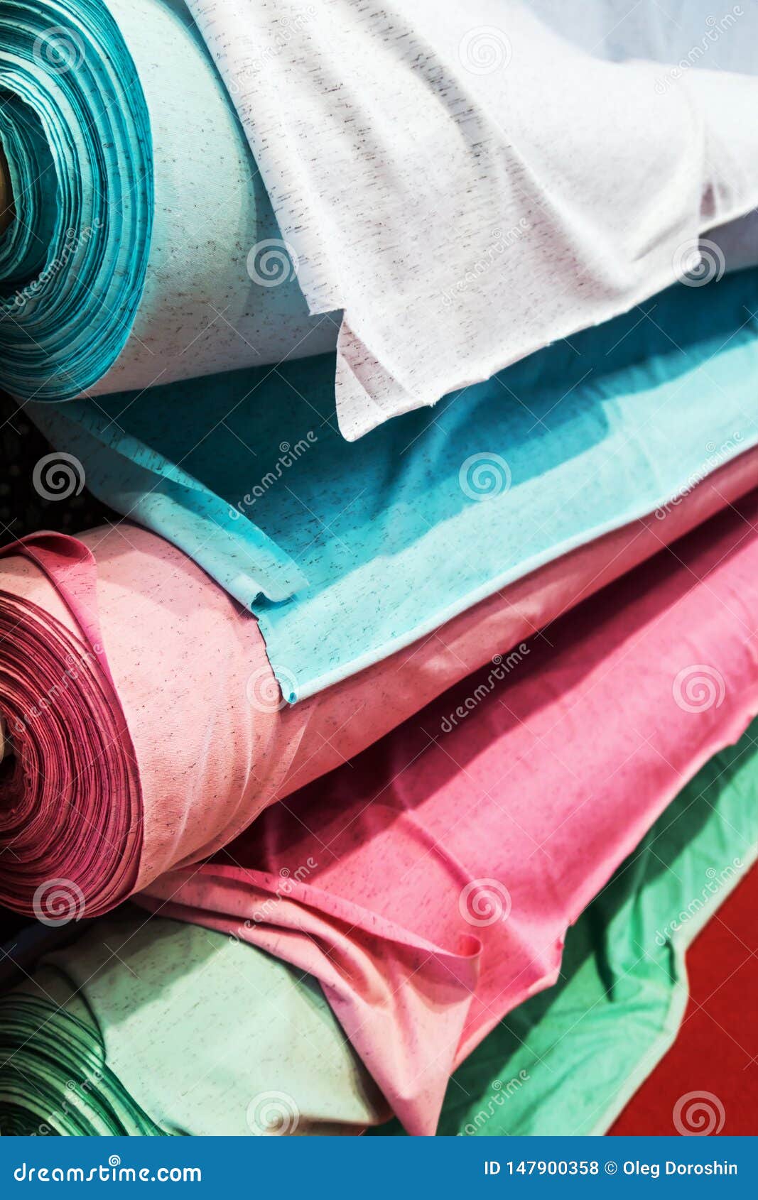 Different Color Textile Fabrics in Rolls at the Factory Stock Photo
