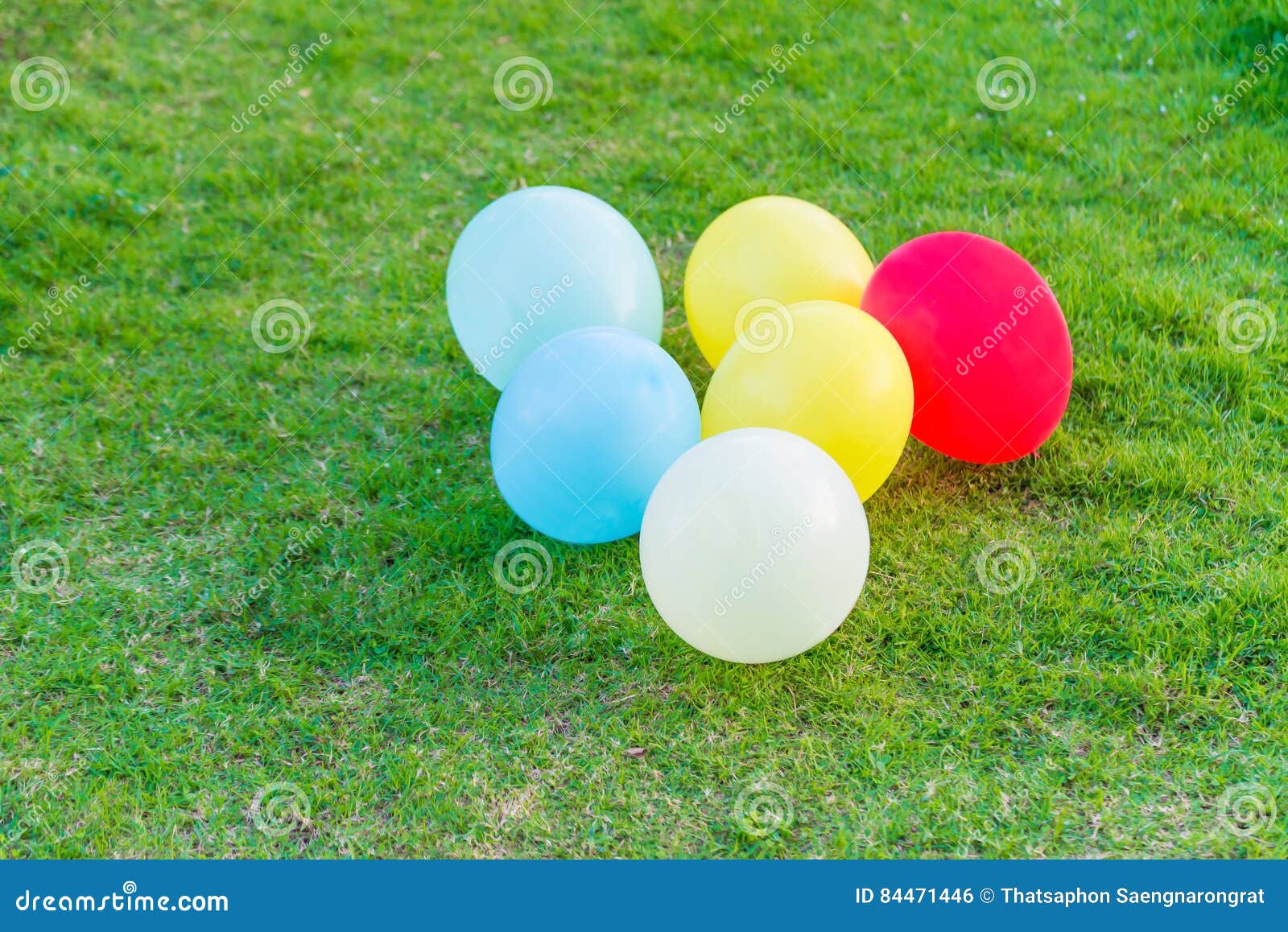 Different Colored Balloons in the Grass. Stock Photo Image of bright