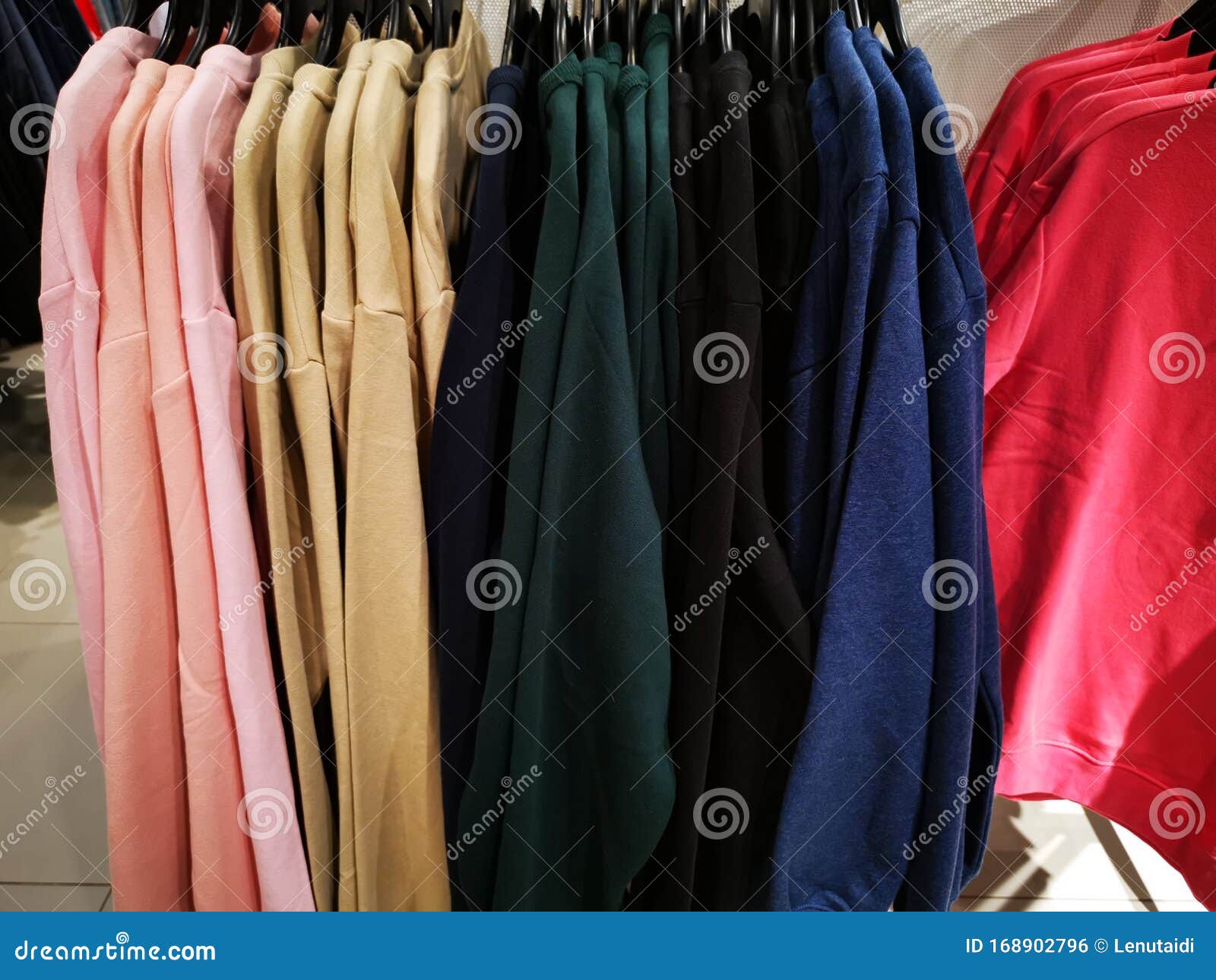 Different Colored Shirts Hanging in a Store Stock Photo - Image of ...