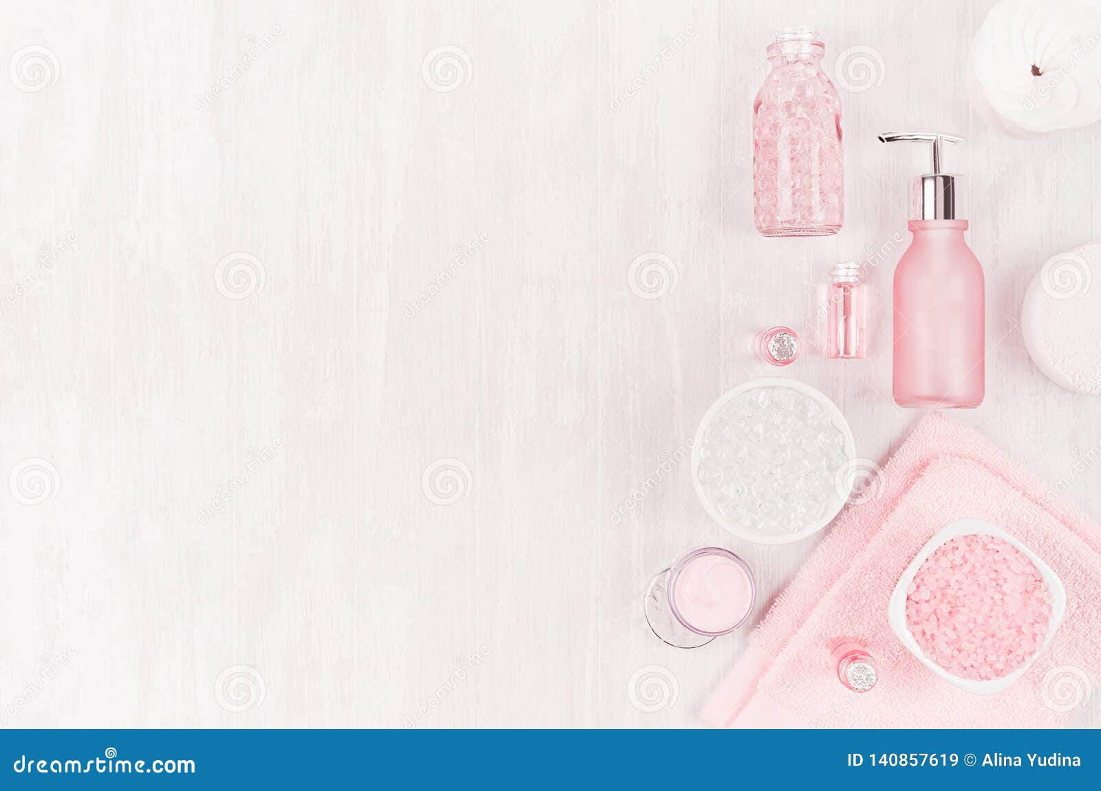 Different cosmetic products and accessories in pink and silver