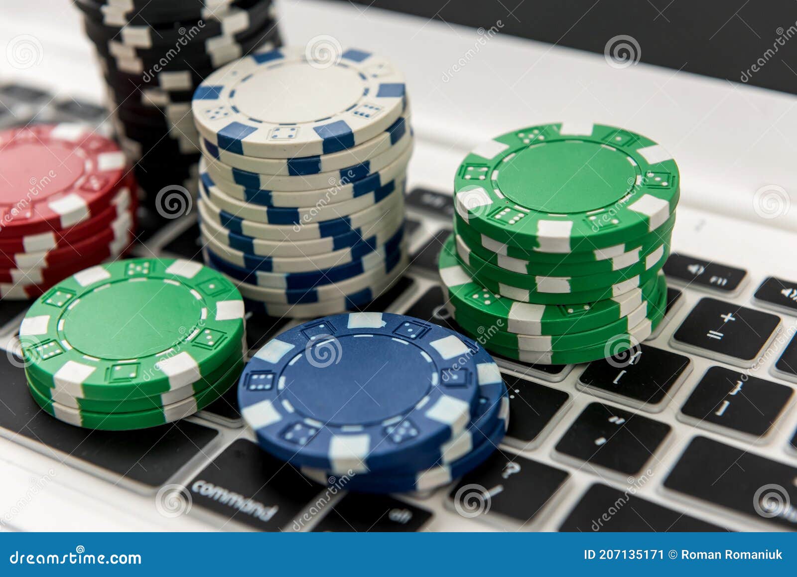 Different of Cost Casino Chips Stacking on a Laptop. Gabmling Stock