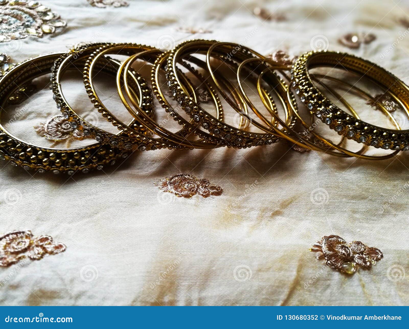 Different Designed Gold Bangles in Silk Background Stock Photo Image