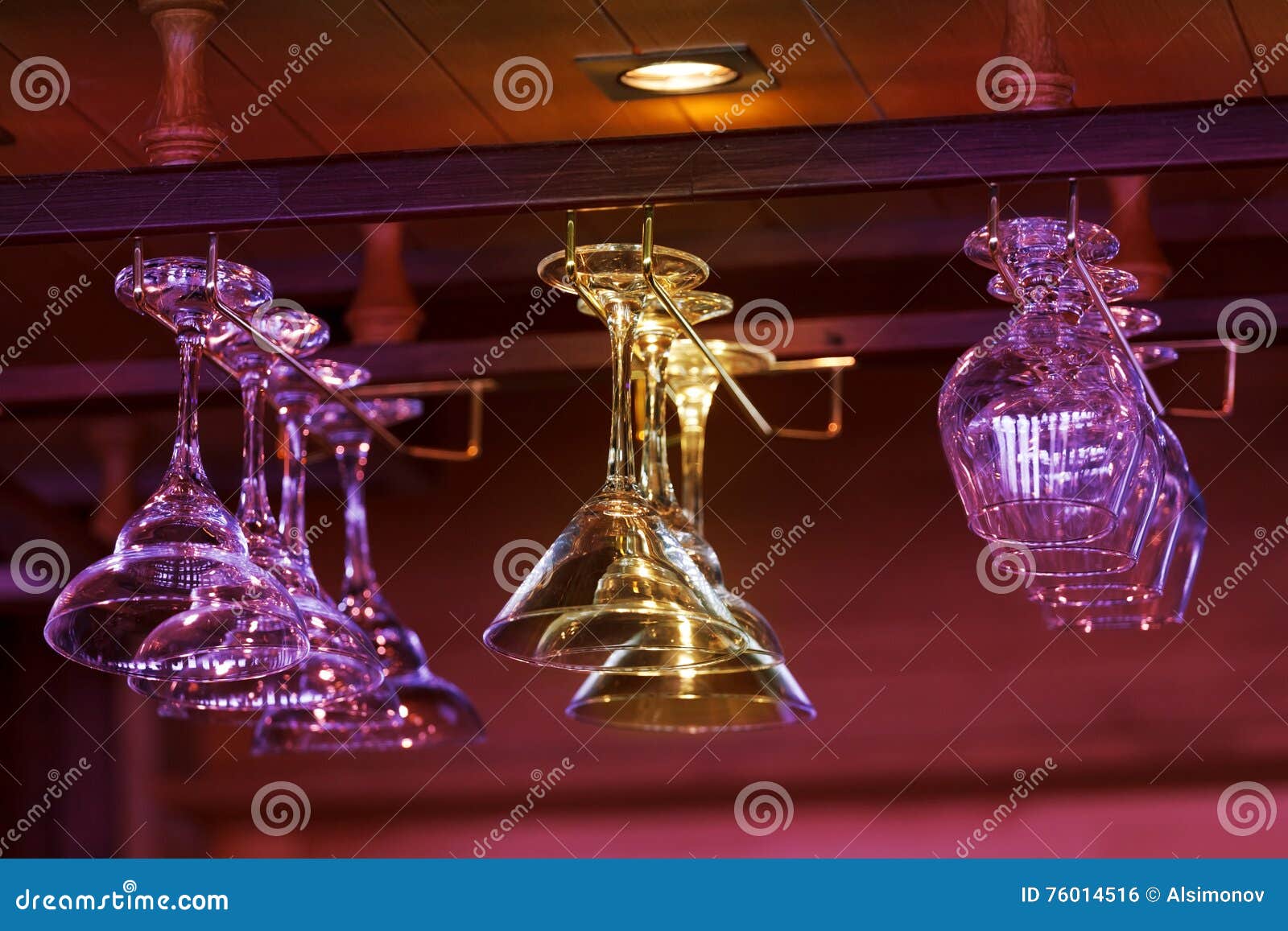 Different Glasses Hanging Over the Bar. Soft Focus. Stock Photo Image