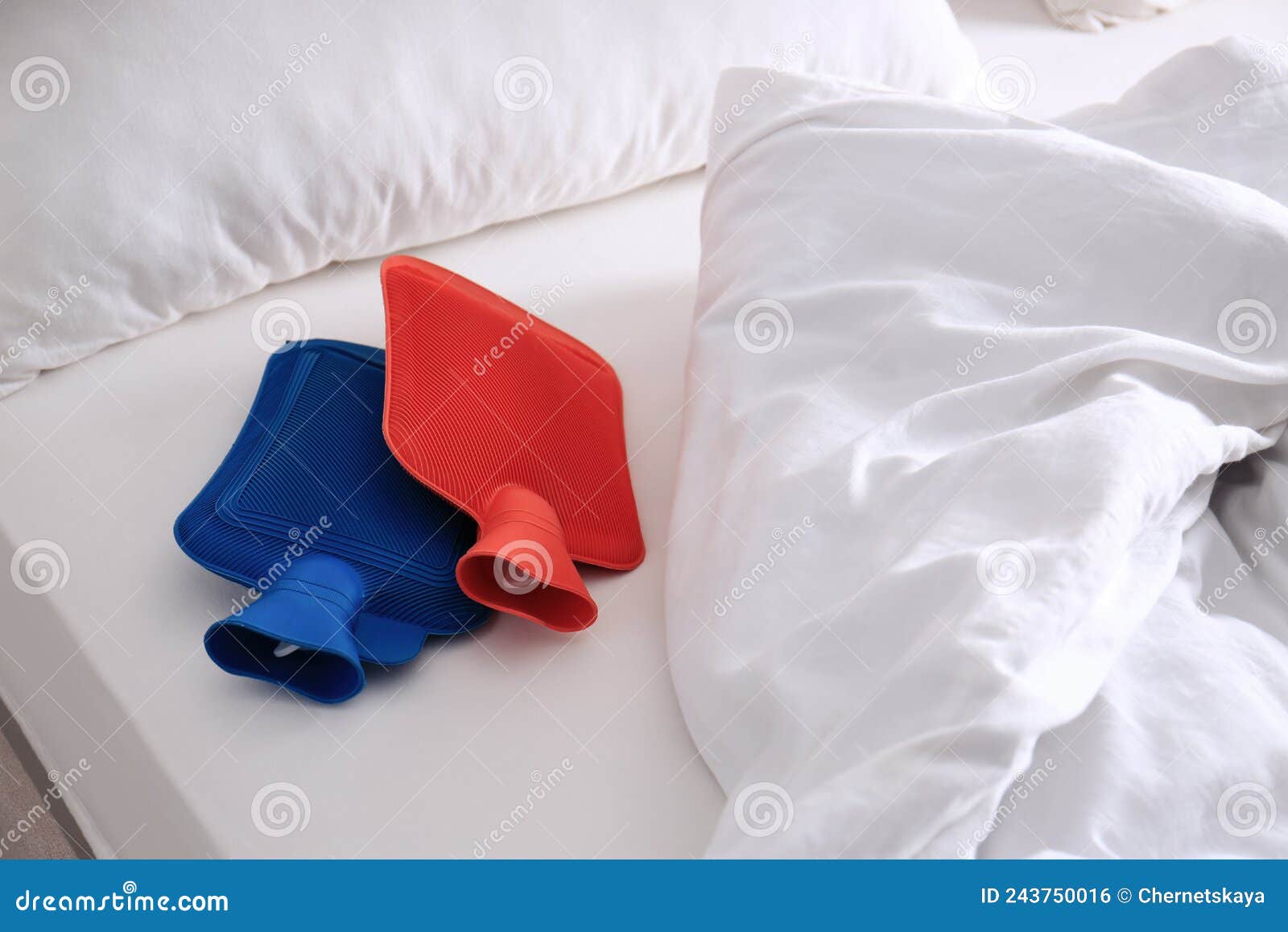 Different Hot Water Bottles on White Bed Stock Photo Image of medicine, care 243750016