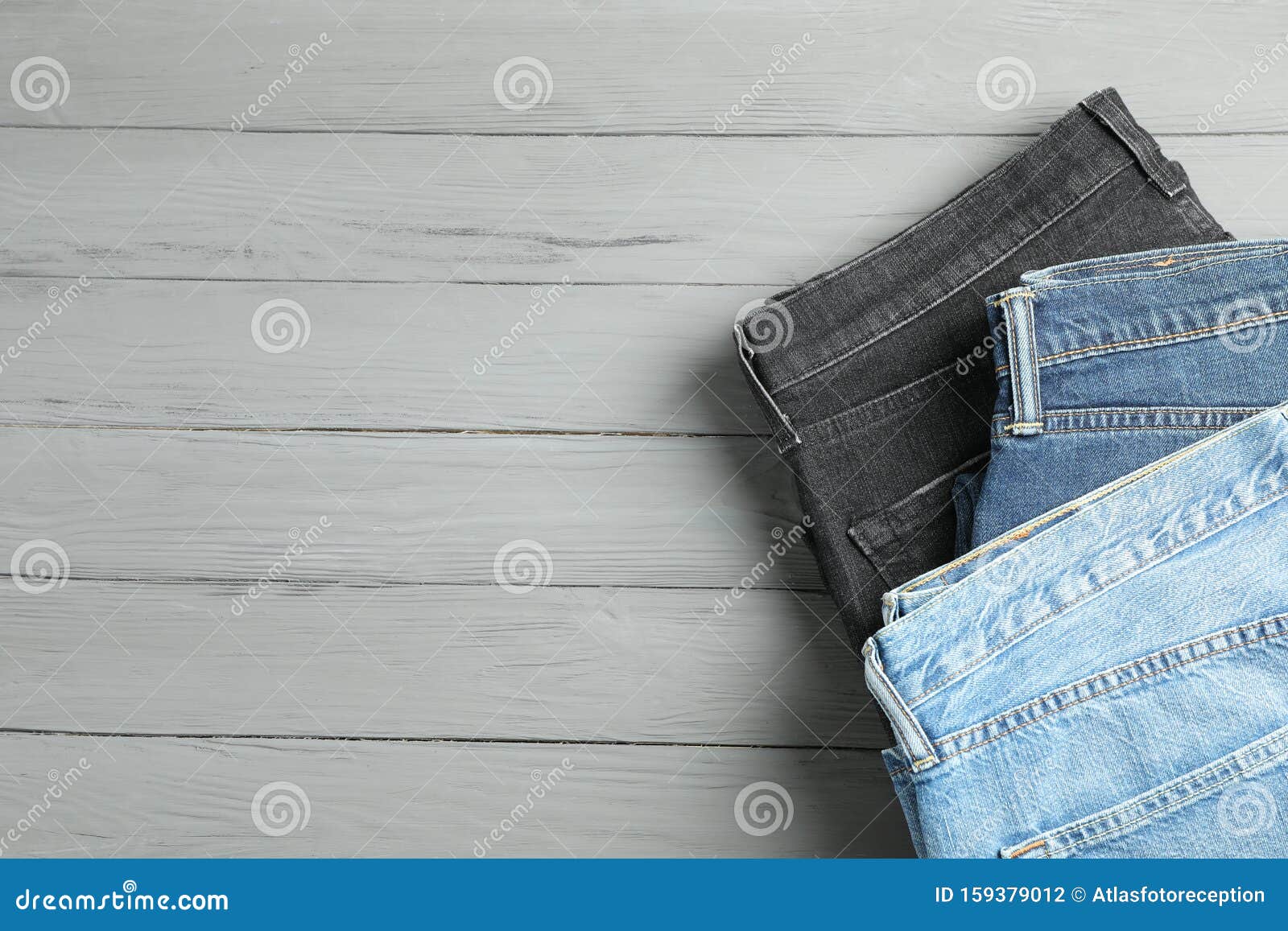 Different Jeans on Grey Wooden Background Stock Photo - Image of wear ...