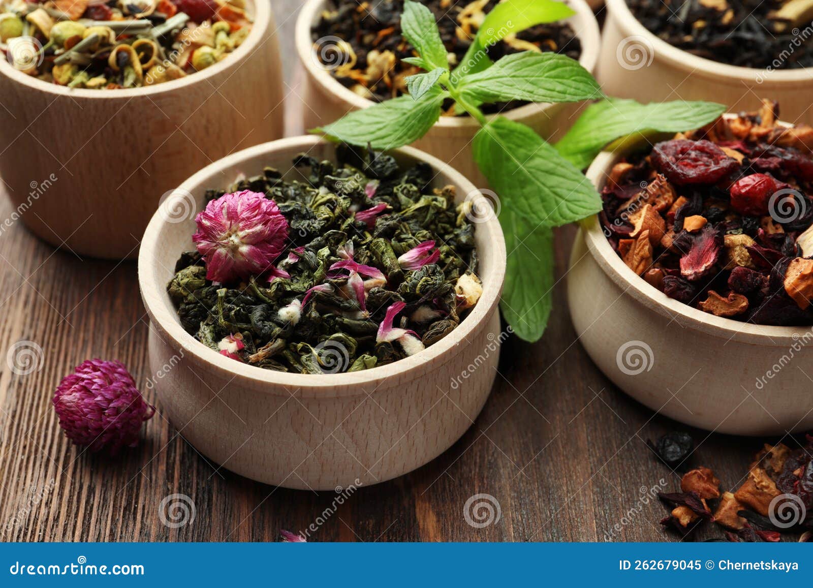 Different Kinds of Dry Herbal Tea in Bowls on Wooden Table Stock Image