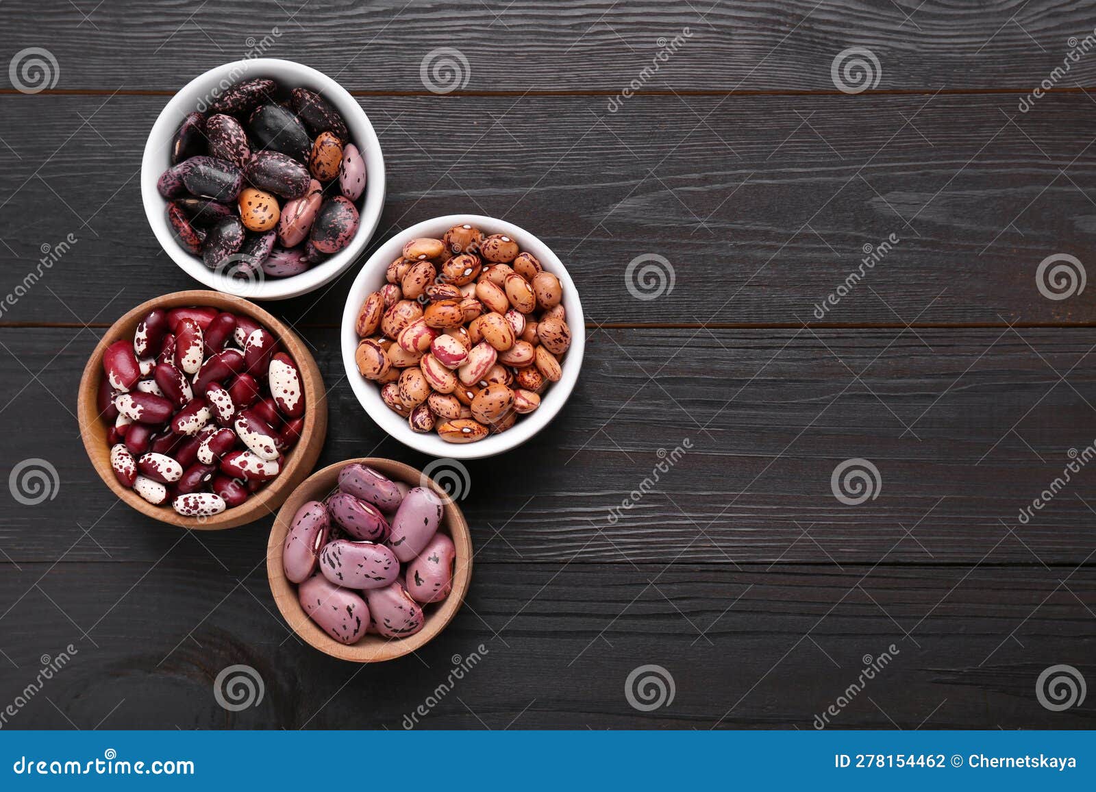 Different Kinds of Dry Kidney Beans on Wooden Table, Flat Lay. Space