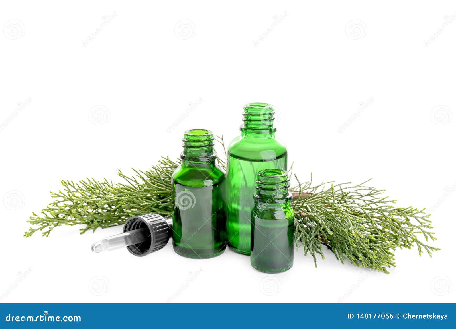 Different Little Bottles with Essential Oils and Pine Branches Stock