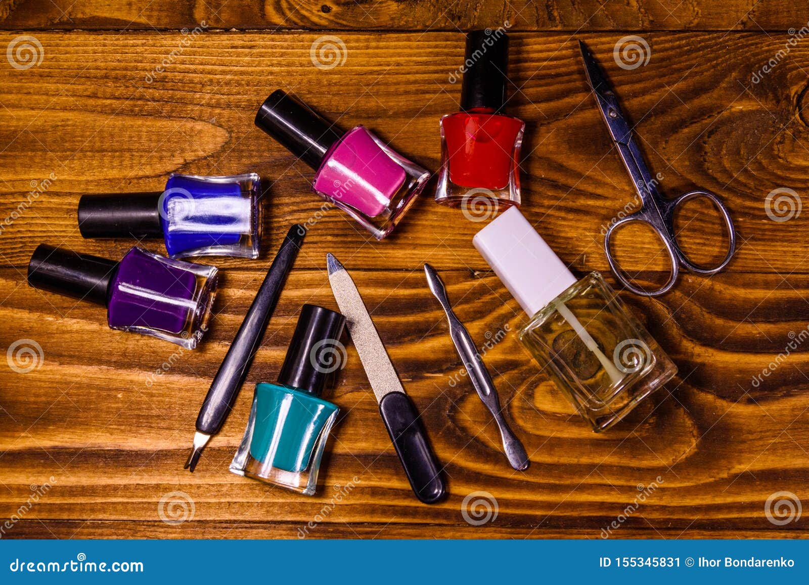 Different Manicure Tools and Nail Polishes on Wooden Table. Top View