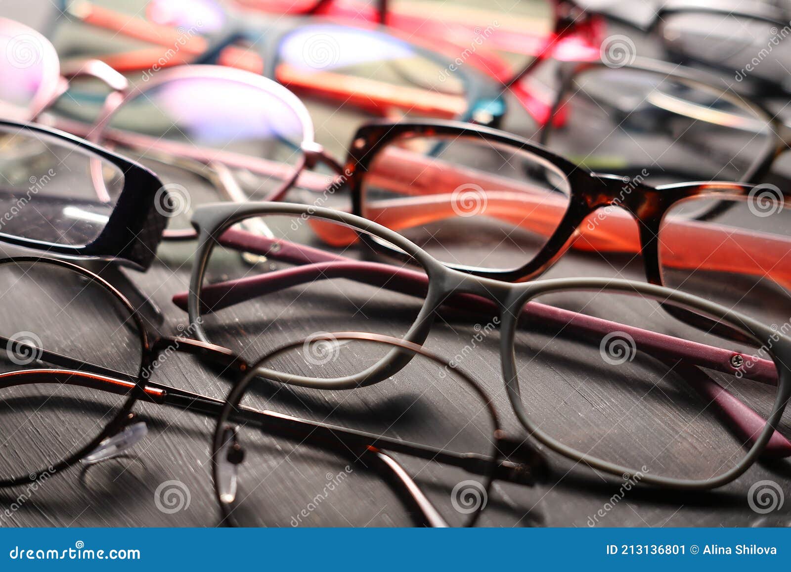 Different Multicolored Eyeglass Frames Closeup on Gray Background