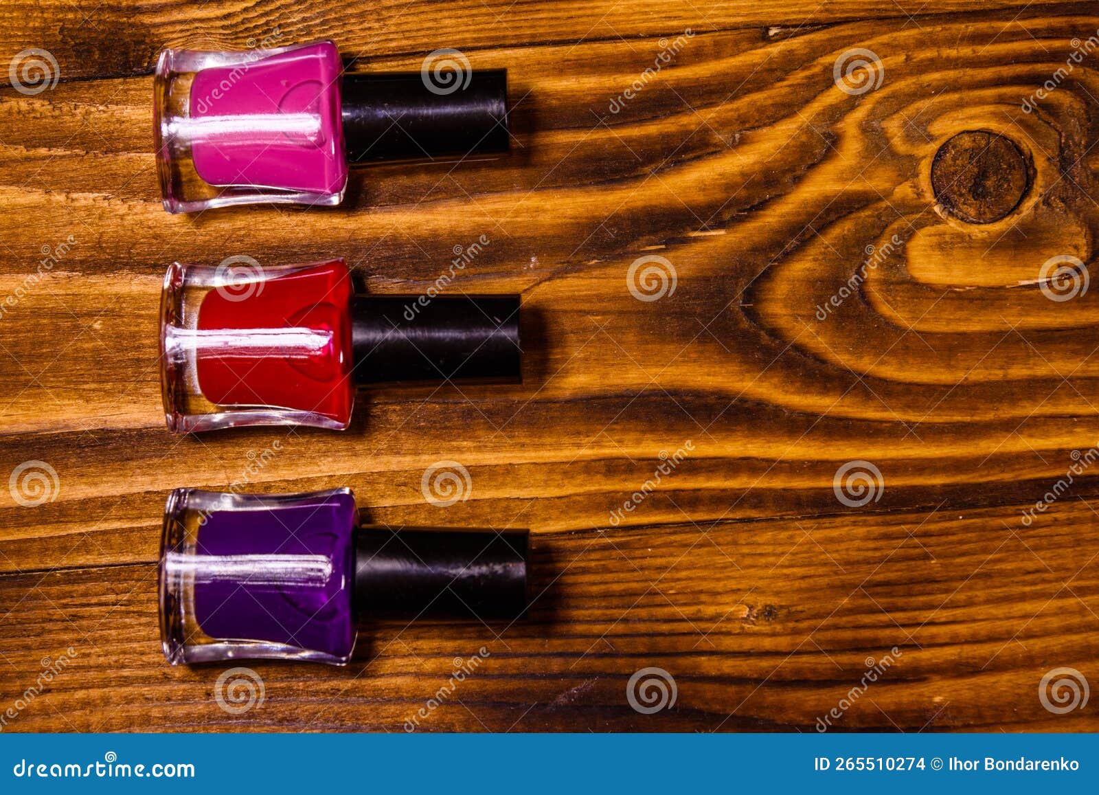 Different Nail Polishes on a Wooden Table. Top View Stock Photo Image