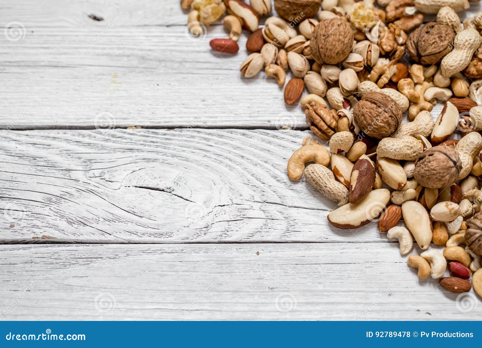 different nuts on white wooden background ,