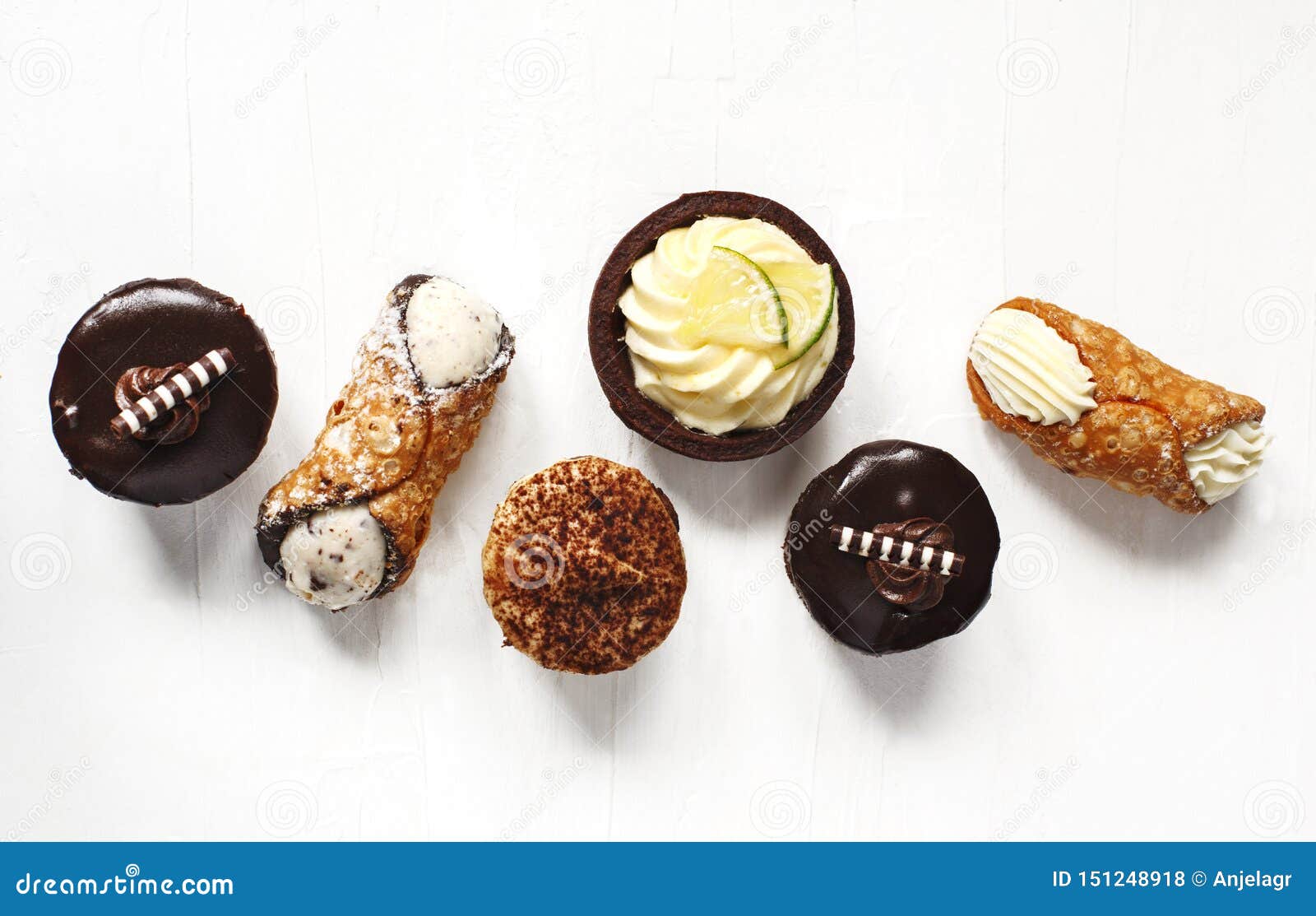 different pastries on white background: cannoli with ricotta, tartlets filled with citrus cream, fudge cake, tiramisu cake.