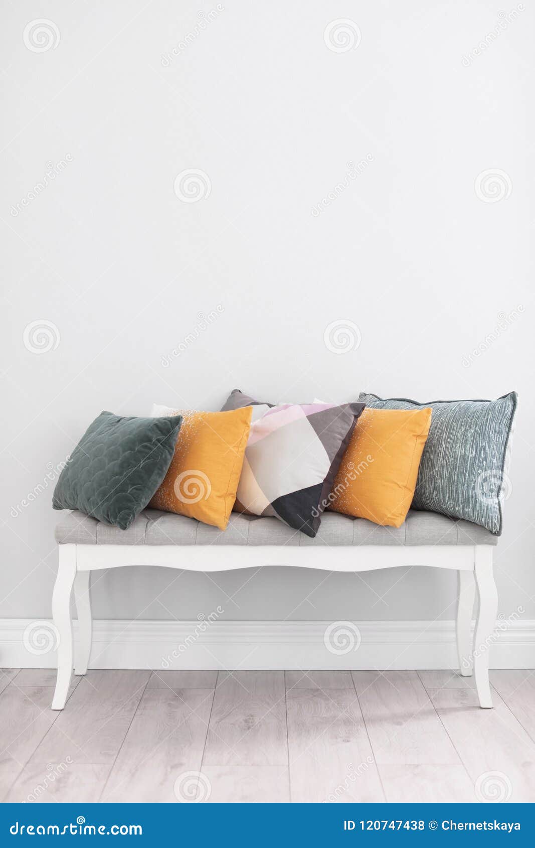Different Pillows on Couch Near Light Wall Stock Photo Image of