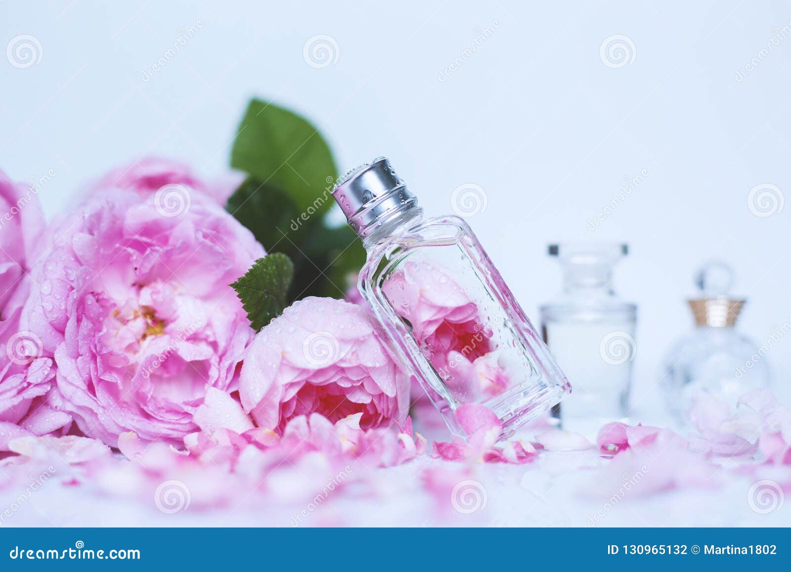 Different Small Bottle of Perfume with Pink Flowers Stock Photo Image