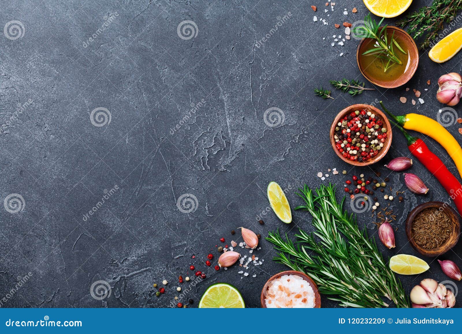 different spices and herbs on black stone table top view. ingredients for cooking. food background.