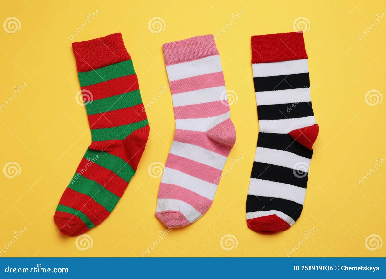 Different Striped Socks on Yellow Background, Flat Lay Stock Photo